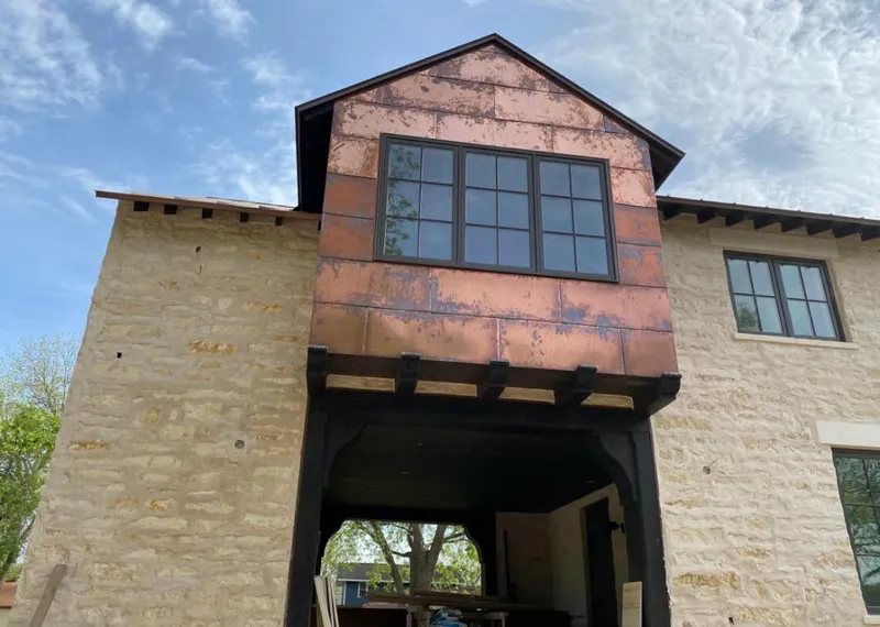 Copper metal panel facade on a stone building for Roof Repair in Scottsboro