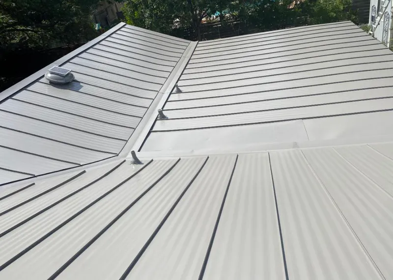 Solar attic fan installed on a metal roof for Roof Ventilation in Scottsboro